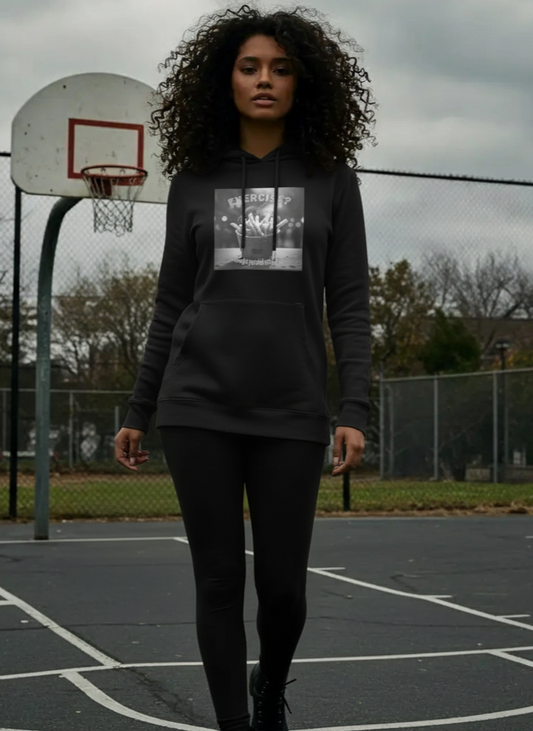 Person wearing a black hoodie with a graphic design on a basketball court
